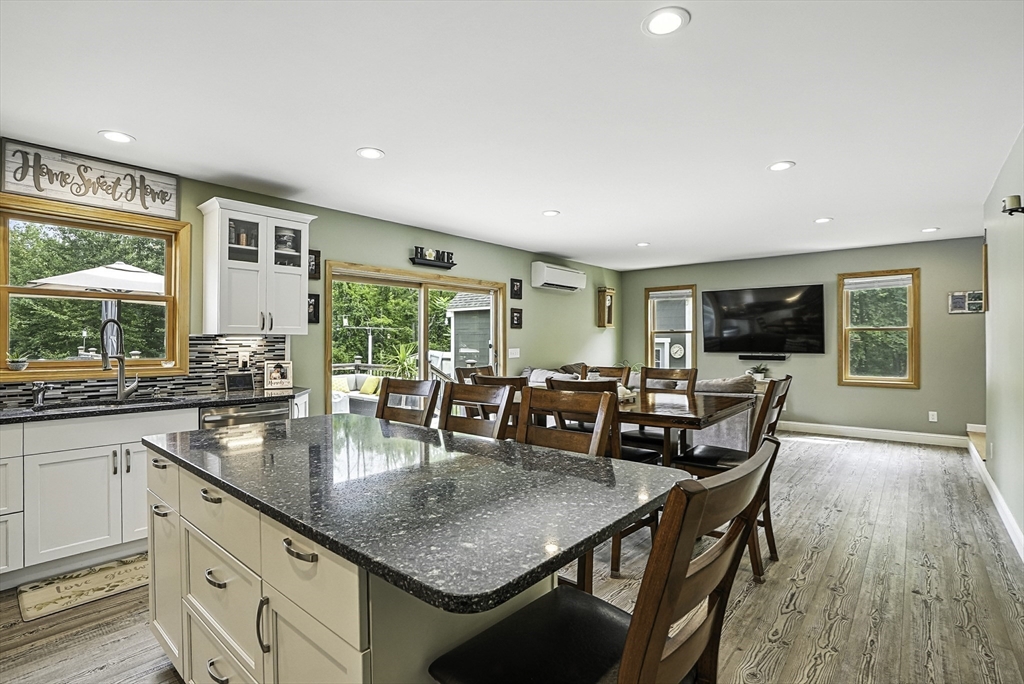 133 Rowley Hill Road Sterling, MA 01564 - Photo 4 of 41 a living room with stainless steel appliances granite countertop a table chairs and a wooden floor