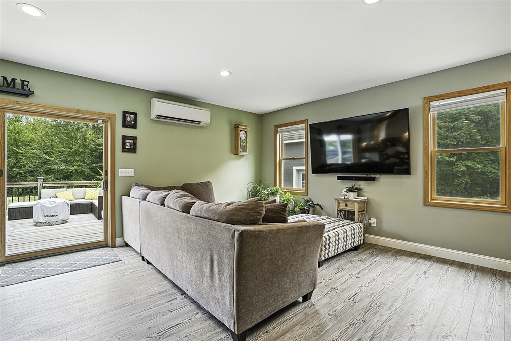 133 Rowley Hill Road Sterling, MA 01564 - Photo 6 of 41 a living room with furniture and a flat screen tv