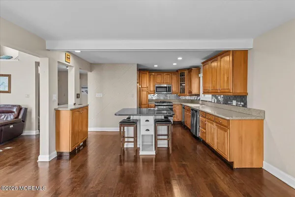 a kitchen with granite countertop cabinets sink and window