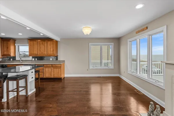 a kitchen with granite countertop a sink stainless steel appliances and cabinets