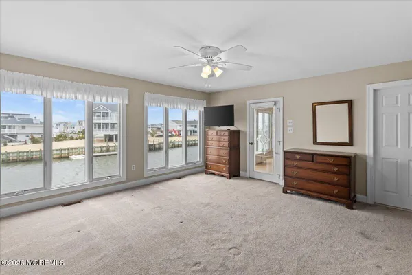 a spacious bedroom with a large bed and a balcony view