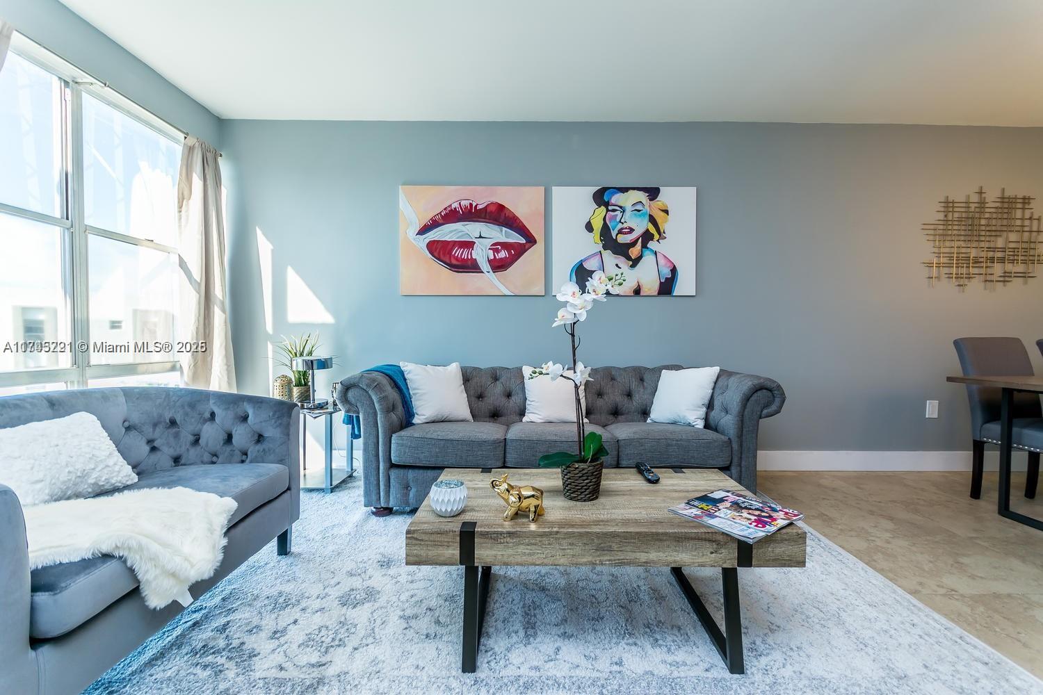 a living room with furniture rug and window