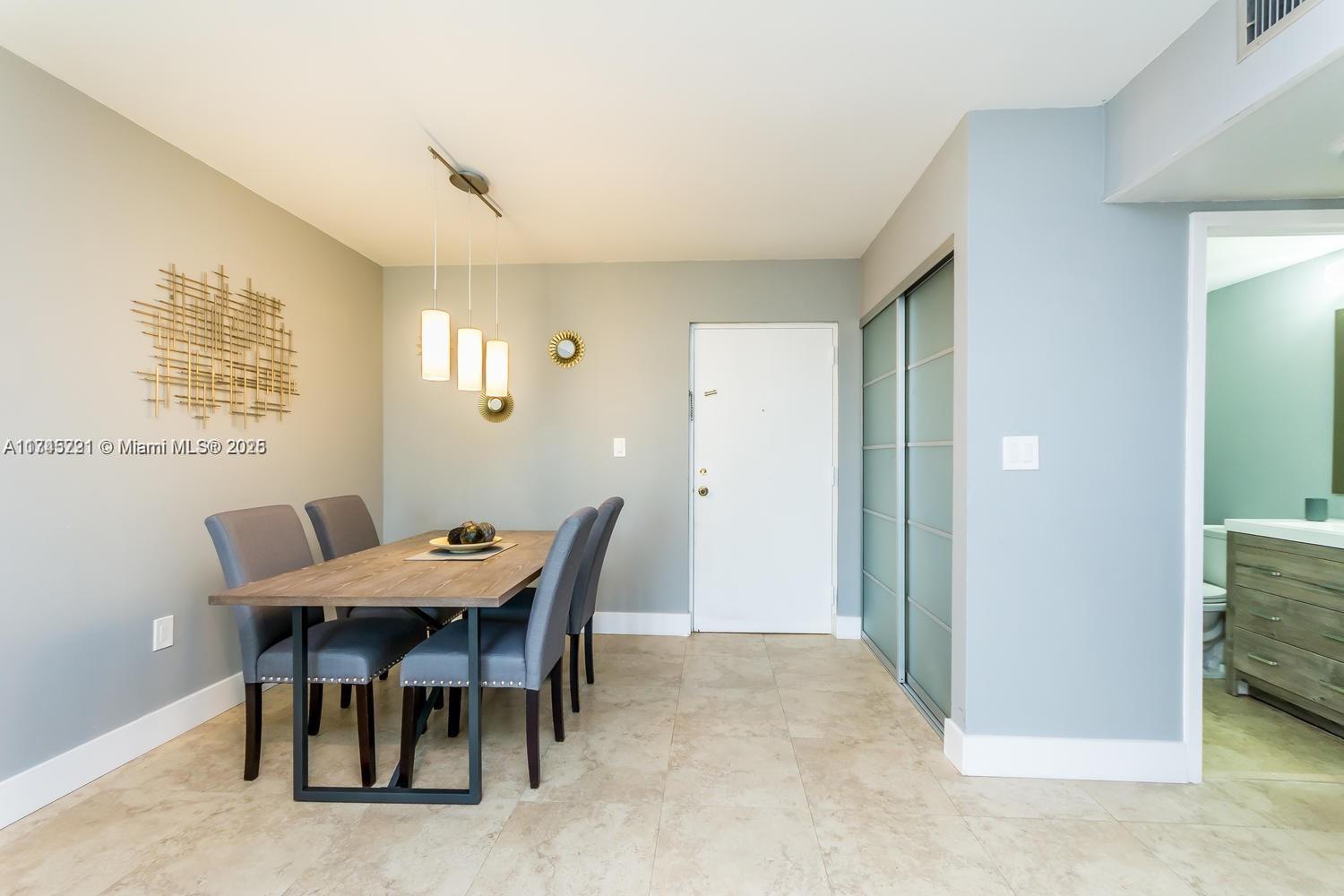 17620 Atlantic Boulevard, Unit 519 Sunny Isles Beach, FL 33160 - Photo 16 of 33 a view of a dining room with furniture