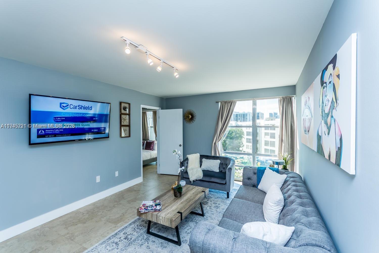 17620 Atlantic Boulevard, Unit 519 Sunny Isles Beach, FL 33160 - Photo 25 of 33 a living room with furniture and a large window