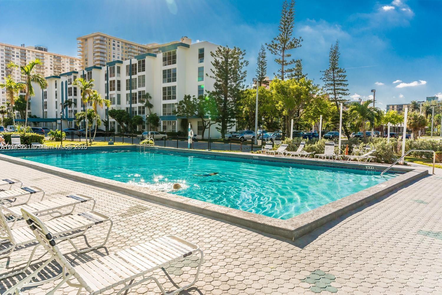 17620 Atlantic Boulevard, Unit 519 Sunny Isles Beach, FL 33160 - Photo 30 of 33 a view of a swimming pool with a garden and plants