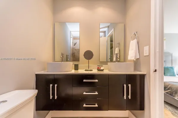 a bathroom with a sink a toilet and mirror
