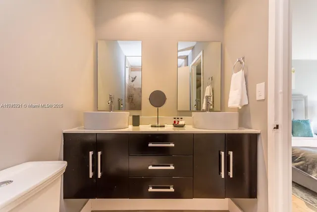 a bathroom with a sink a toilet and mirror