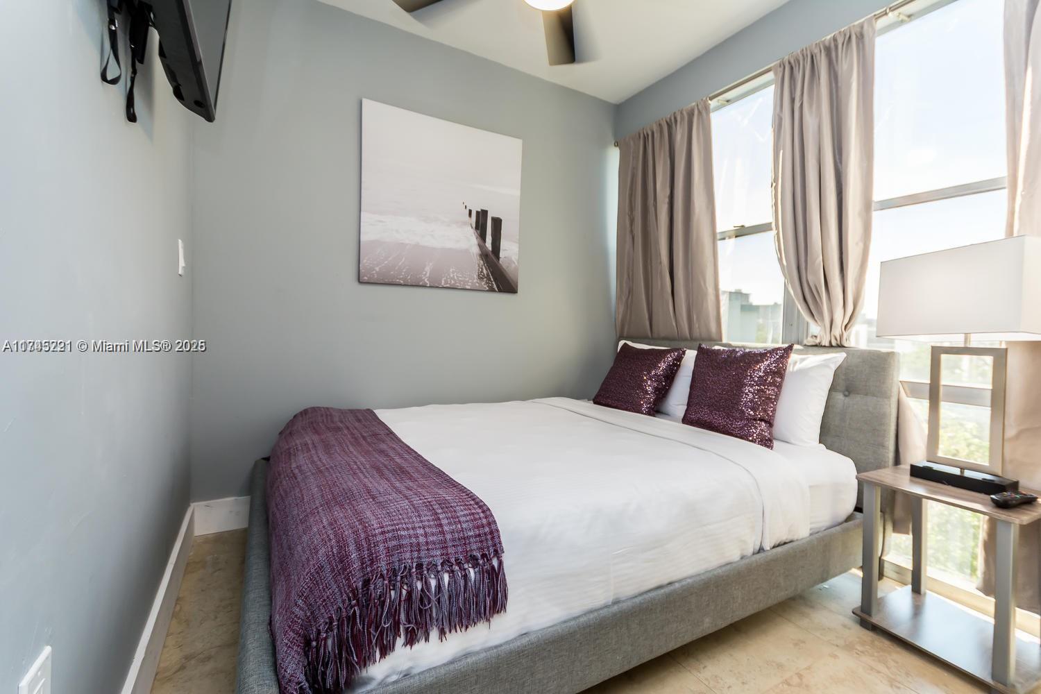 17620 Atlantic Boulevard, Unit 519 Sunny Isles Beach, FL 33160 - Photo 7 of 33 a bedroom with a bed and window