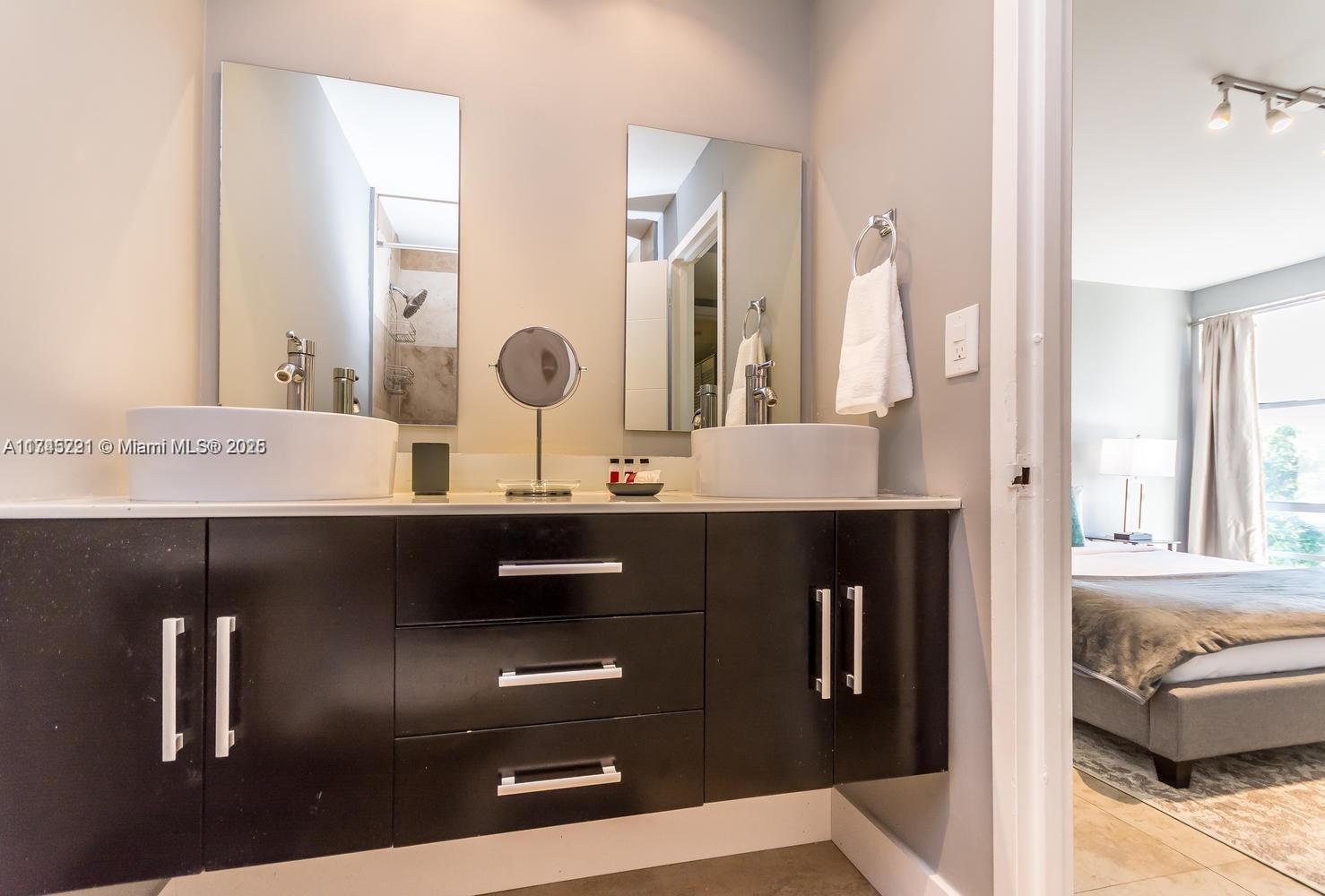 17620 Atlantic Boulevard, Unit 519 Sunny Isles Beach, FL 33160 - Photo 10 of 33 a bathroom with a sink and a mirror