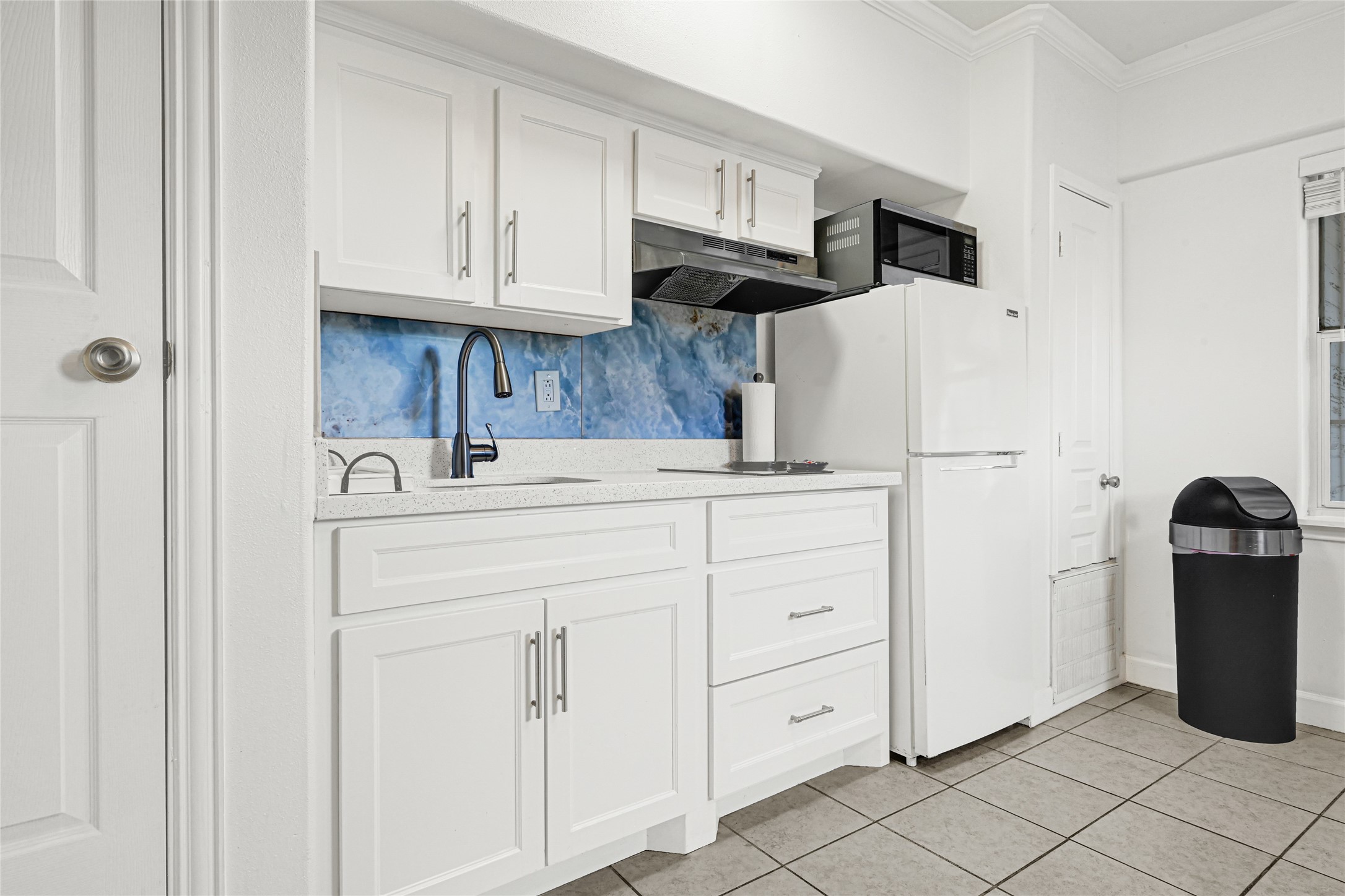 2809 Tooke Street Houston, TX 77023 - Photo 38 of 50 a kitchen with cabinets and a refrigerator