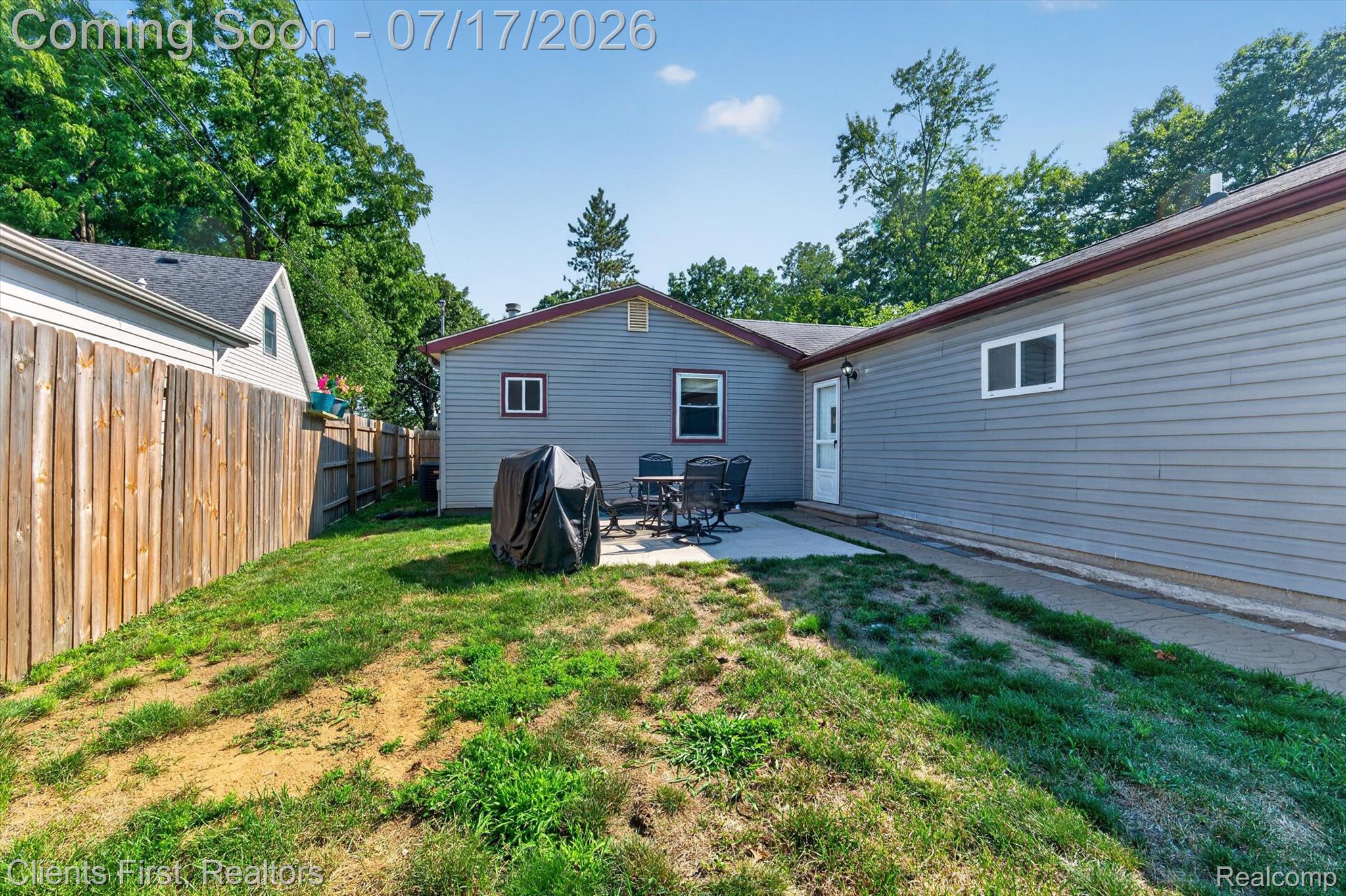 36852 Chase Street Romulus, MI 48174 - Photo 32 of 40 Private backyard featuring a concrete patio, wood privacy fencing, and mature perimeter trees