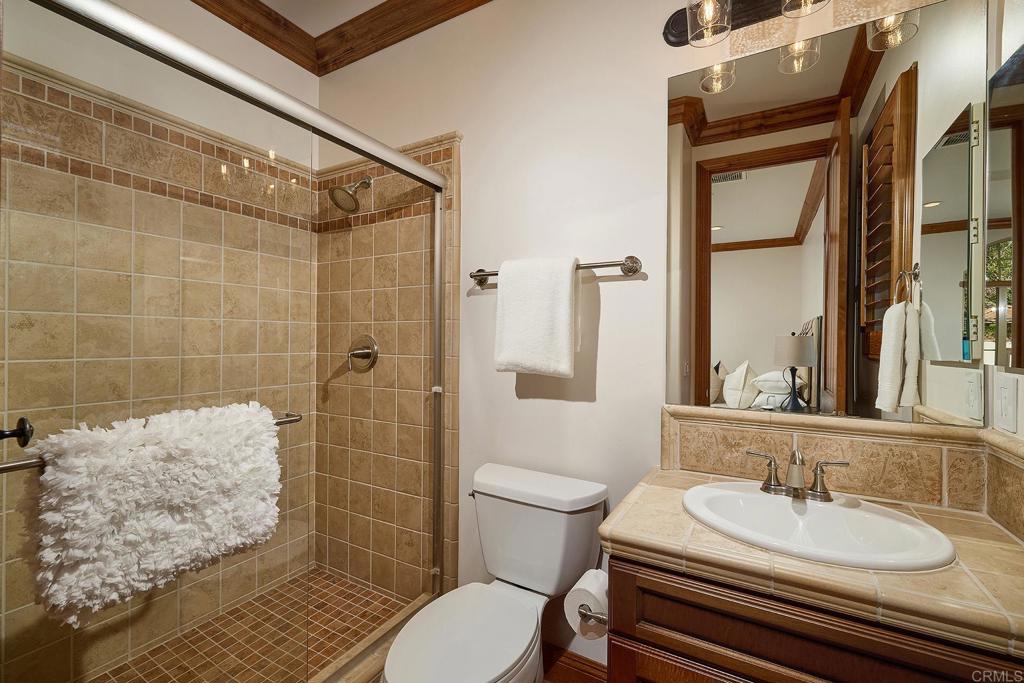 6921 Corte Langosta Carlsbad, CA 92009 - Photo 8 of 20 a bathroom with a sink a toilet and shower