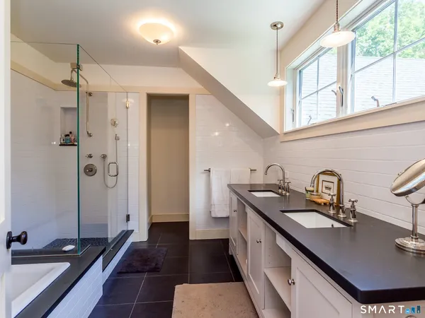 a kitchen with granite countertop a sink stove and refrigerator