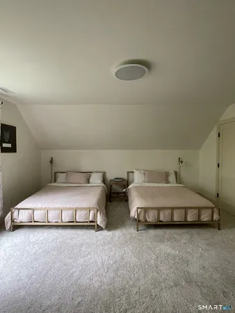 a spacious bedroom with a bed and a cabinets