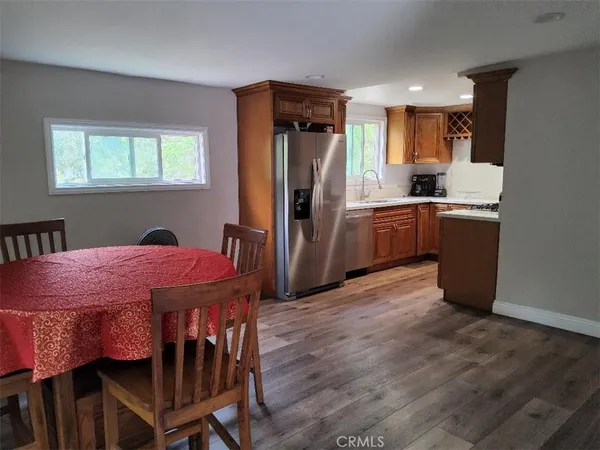 a kitchen with a table chairs refrigerator and microwave