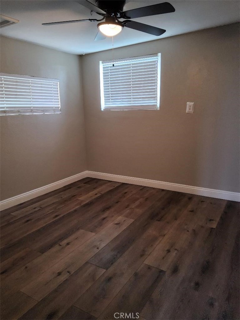 10515 Cypress Avenue Riverside, CA 92505 - Photo 5 of 7 a view of wooden floor and a chandelier fan in a room