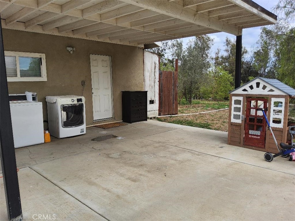 10515 Cypress Avenue Riverside, CA 92505 - Photo 6 of 7 a view of a porch with a floor to ceiling window and a table