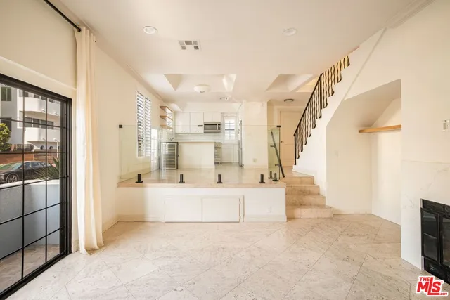 a large white kitchen with a large window