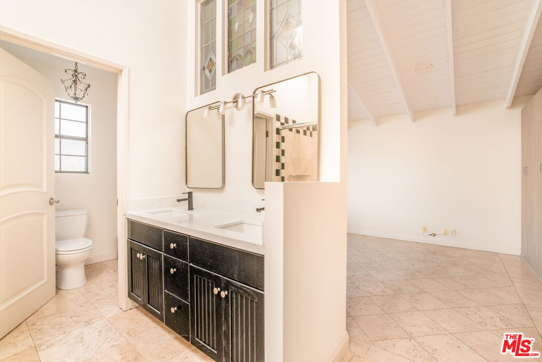 36 Navy Street, Unit 1 Venice, CA 90291 - Photo 28 of 49 a bathroom with a double vanity sink toilet and mirror