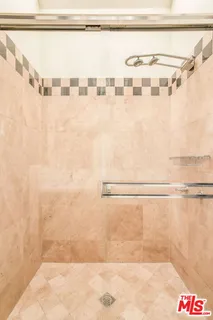 a bathroom with a shower and a sink