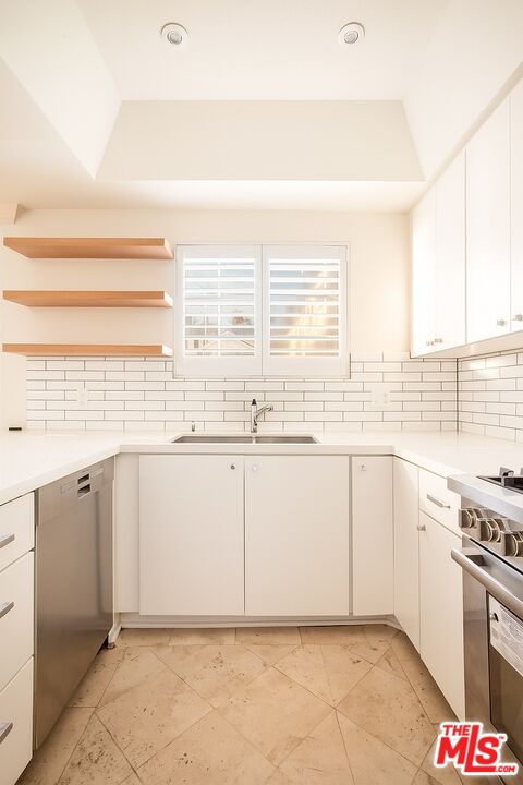 36 Navy Street, Unit 1 Venice, CA 90291 - Photo 8 of 49 a kitchen with granite countertop a sink and a stove