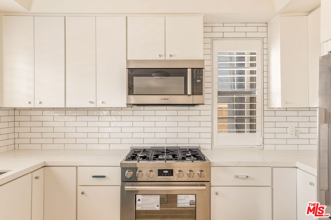 36 Navy Street, Unit 1 Venice, CA 90291 - Photo 9 of 49 a kitchen with granite countertop cabinets stainless steel appliances and a sink