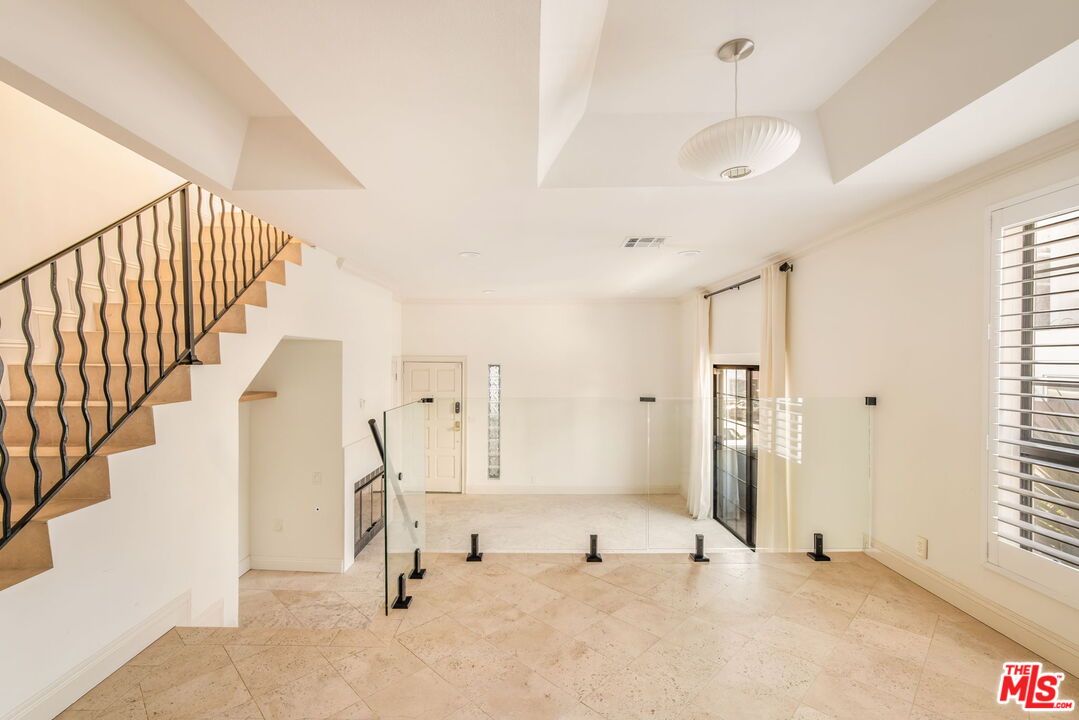 36 Navy Street, Unit 1 Venice, CA 90291 - Photo 10 of 49 a view of empty room with stairs and windows