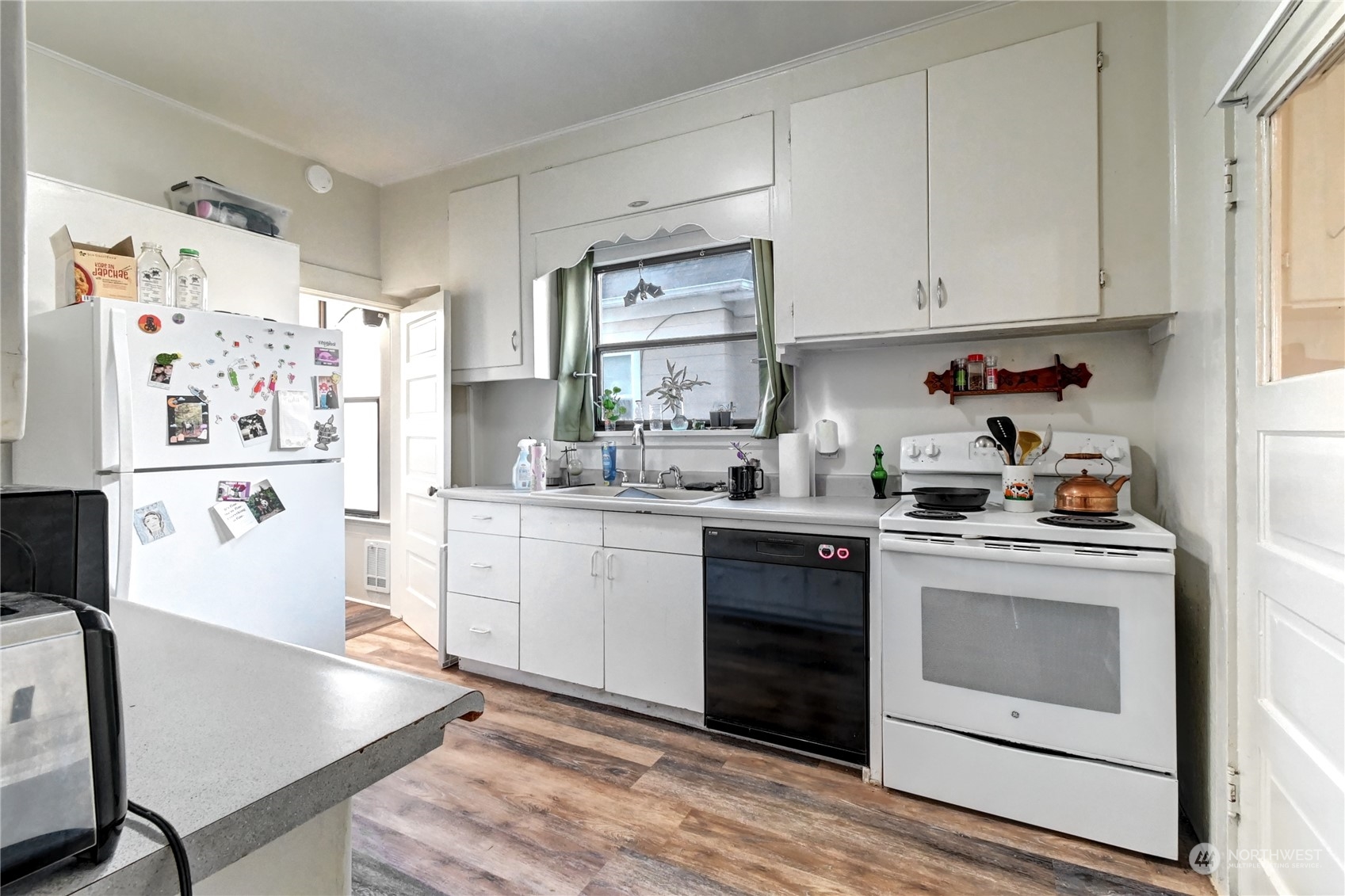 2223 Rockefeller Avenue Everett, WA 98201 - Photo 17 of 21 a kitchen with granite countertop white cabinets and white appliances
