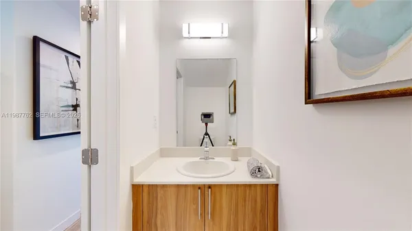 a bathroom with a sink vanity and a mirror