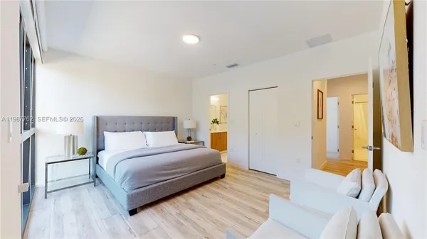 a bedroom with a bed and a lamp