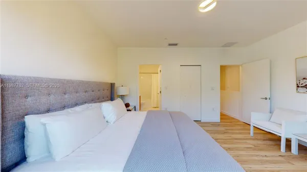 a bed room with a bed and a lamp