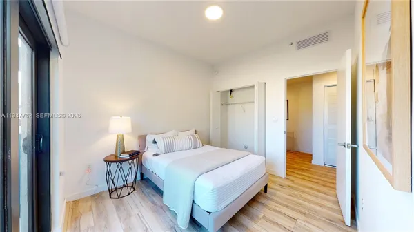 a bedroom with a bed and a mirror