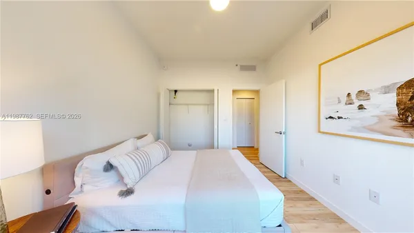 a bedroom with a bed and a mirror