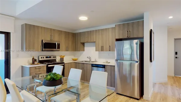 a kitchen with stainless steel appliances a refrigerator stove microwave and cabinets