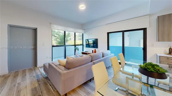 a living room with furniture and a large window