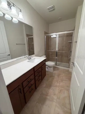 a bathroom with a sink double vanity and a mirror