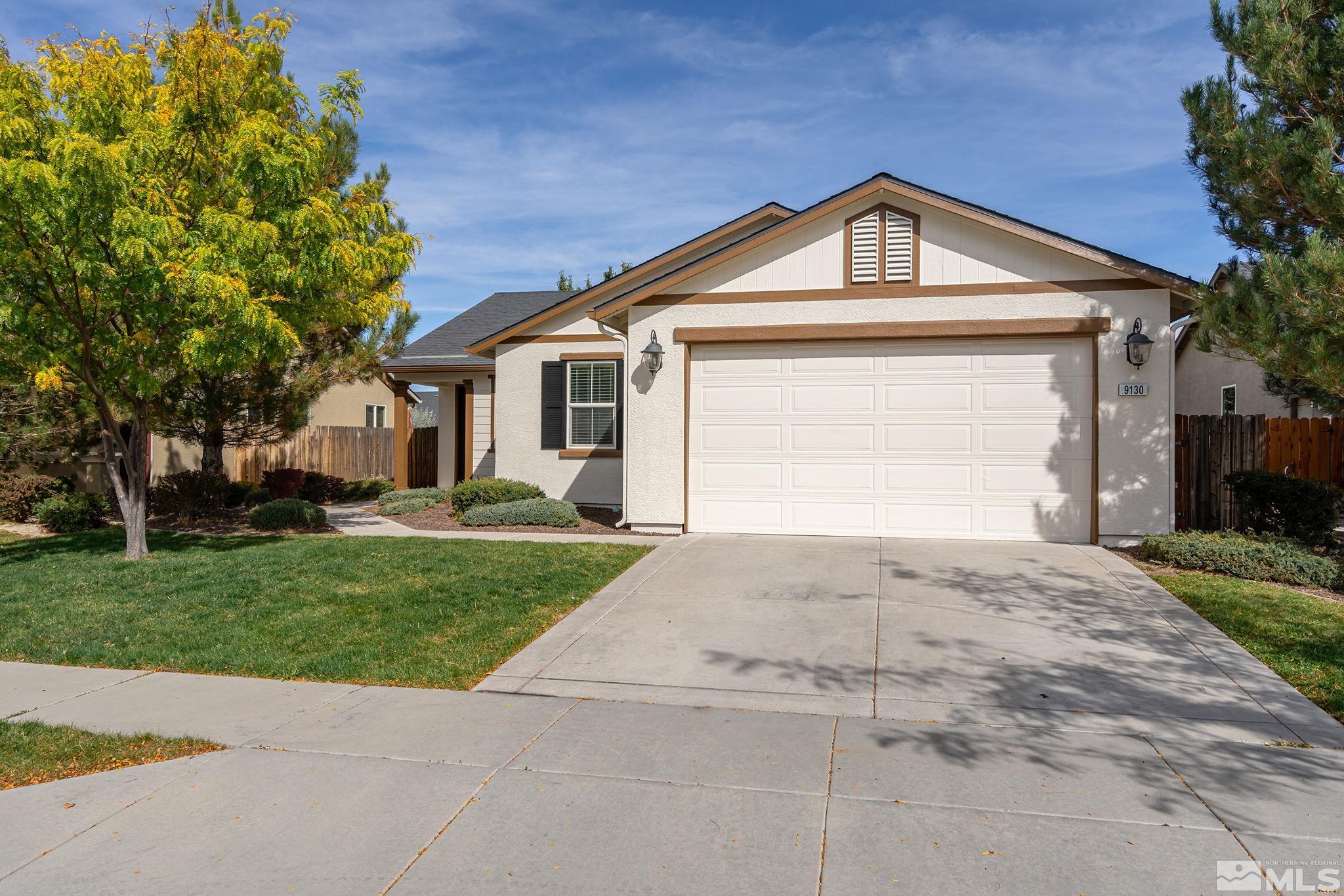 9130 Andraste Way Reno, NV 89506 - Photo 1 of 19 a front view of a house with a yard and garage