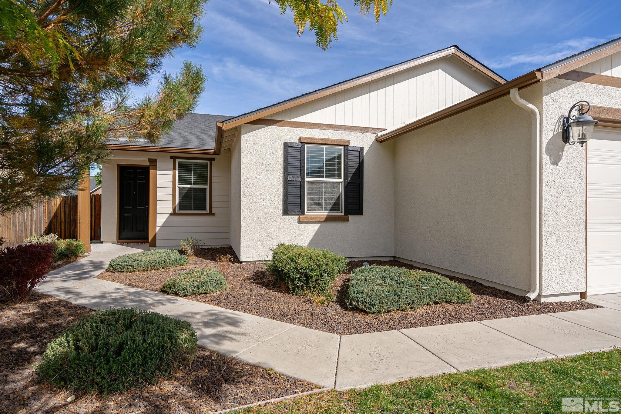 9130 Andraste Way Reno, NV 89506 - Photo 3 of 19 a front view of a house with garden