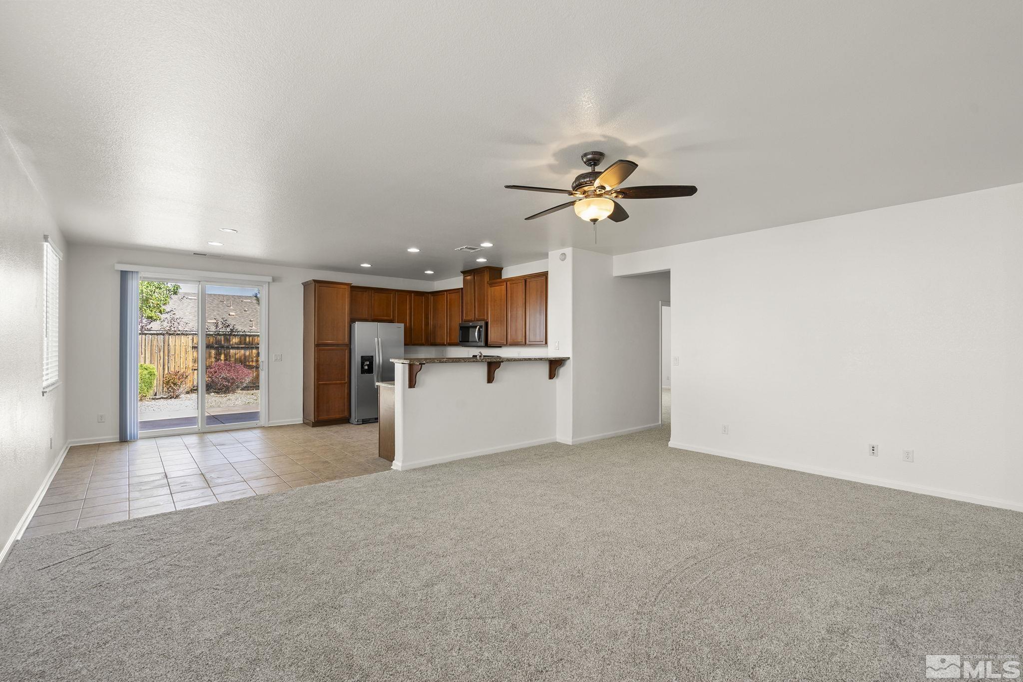 9130 Andraste Way Reno, NV 89506 - Photo 4 of 19 a view of a kitchen with a sink and a refrigerator