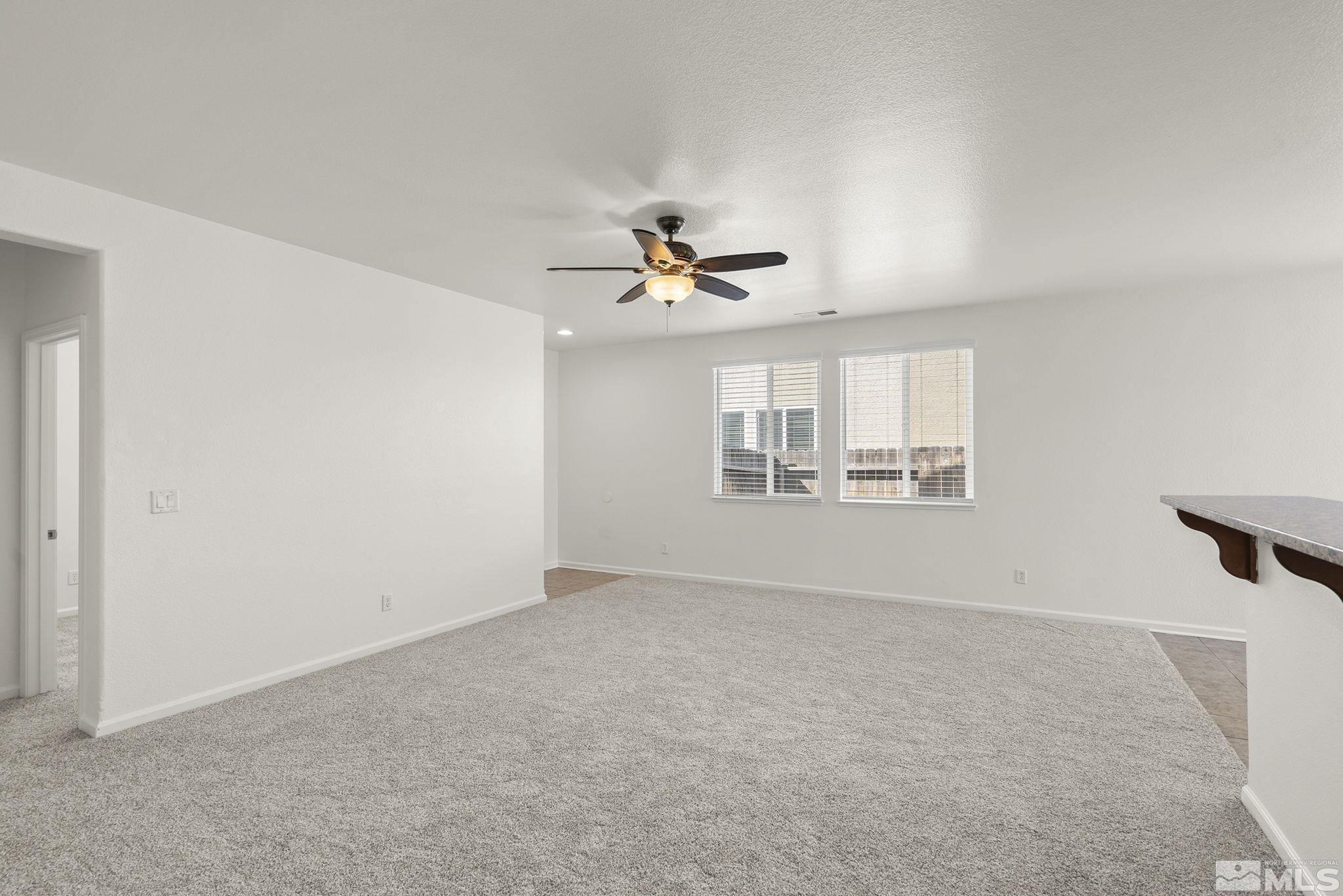 9130 Andraste Way Reno, NV 89506 - Photo 6 of 19 wooden floor in an empty room with a window
