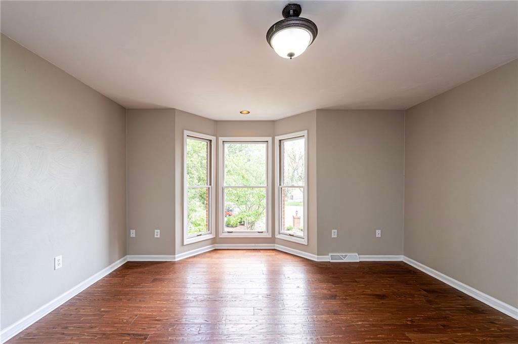 1120 Sandstone Road Greensburg, PA 15601 - Photo 29 of 43 an empty room with wooden floor and windows
