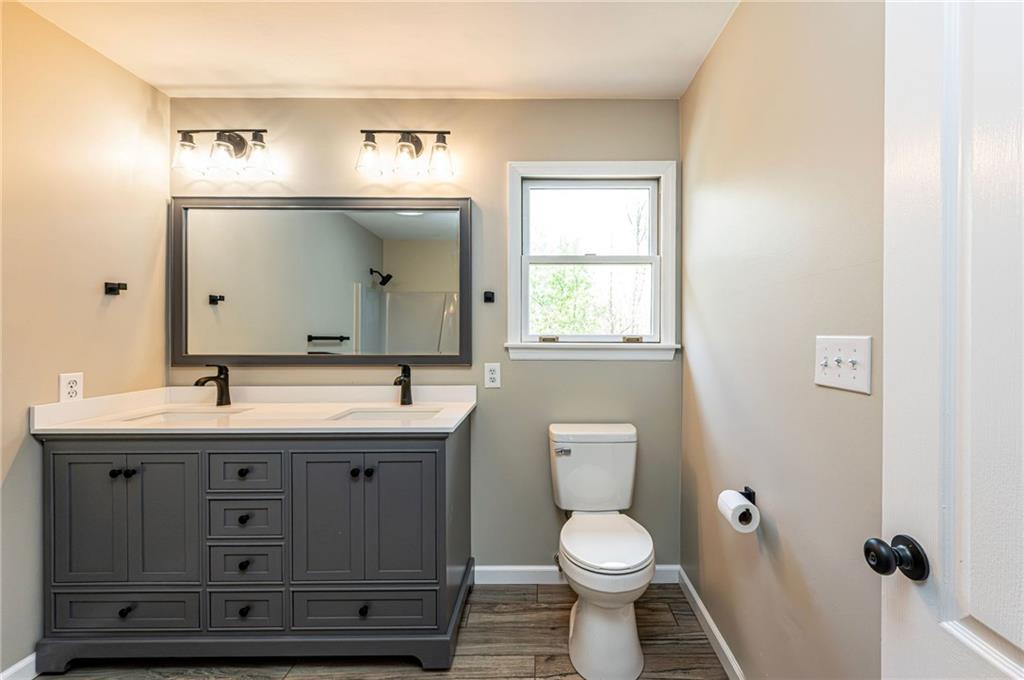 1120 Sandstone Road Greensburg, PA 15601 - Photo 32 of 43 a bathroom with a toilet sink and mirror