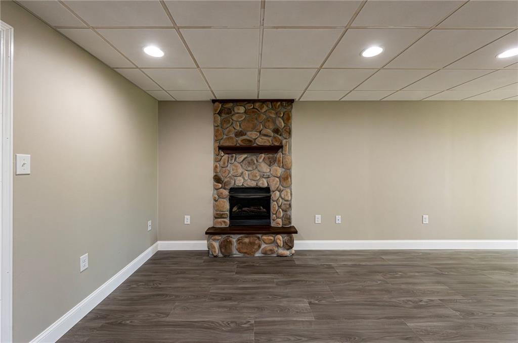 1120 Sandstone Road Greensburg, PA 15601 - Photo 40 of 43 a view of empty room with wooden floor and fireplace