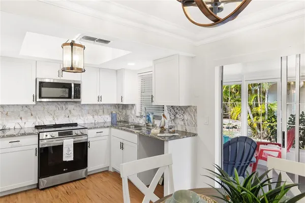 a kitchen with stainless steel appliances kitchen island granite countertop a stove a sink and a microwave