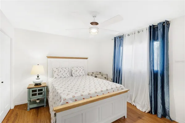 a bedroom with a bed and a flat tv screen on a dresser
