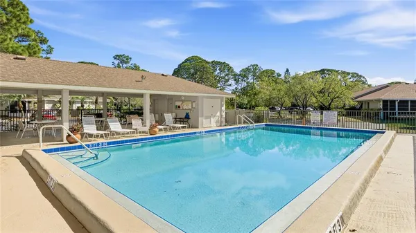 a view of swimming pool with chairs