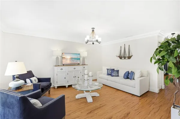 a living room with furniture and a chandelier