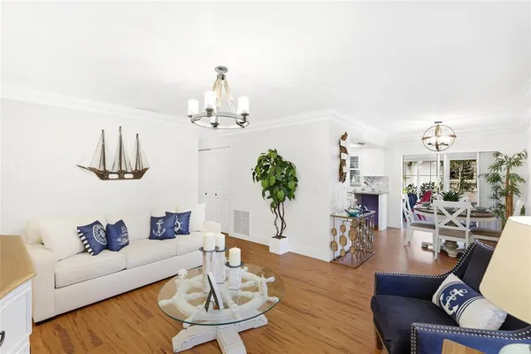 a living room with furniture chandelier and a table