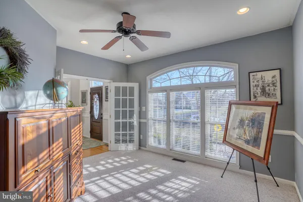 a living room with furniture a dining table and wooden floor