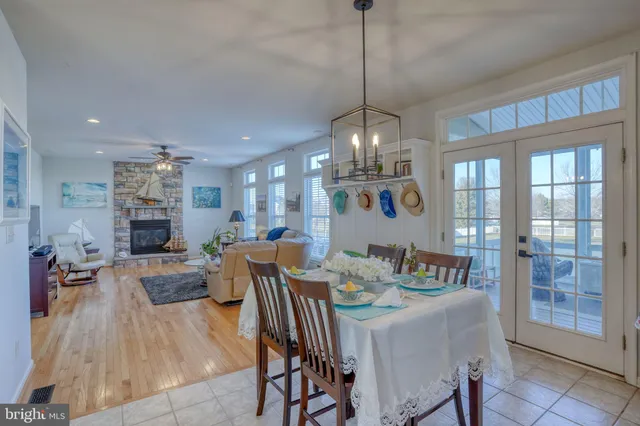 a living room with furniture and floor to ceiling windows